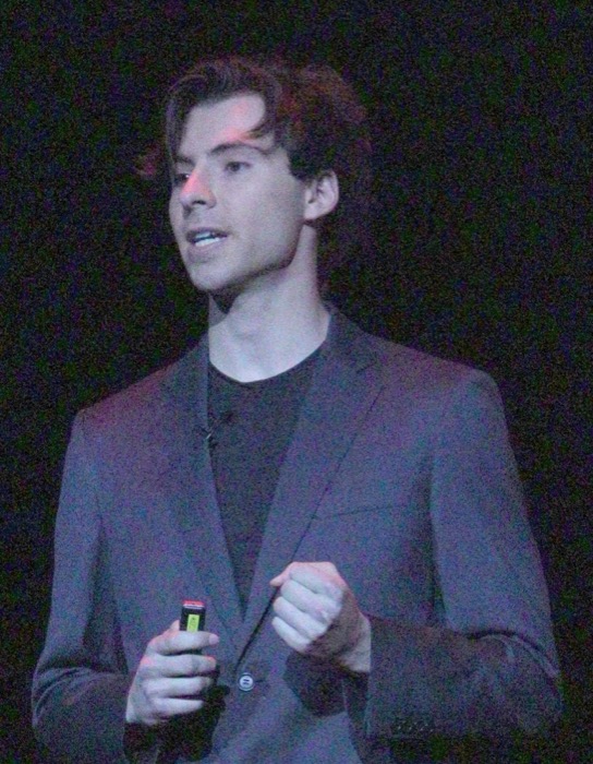 Teo Blind speaking on stage